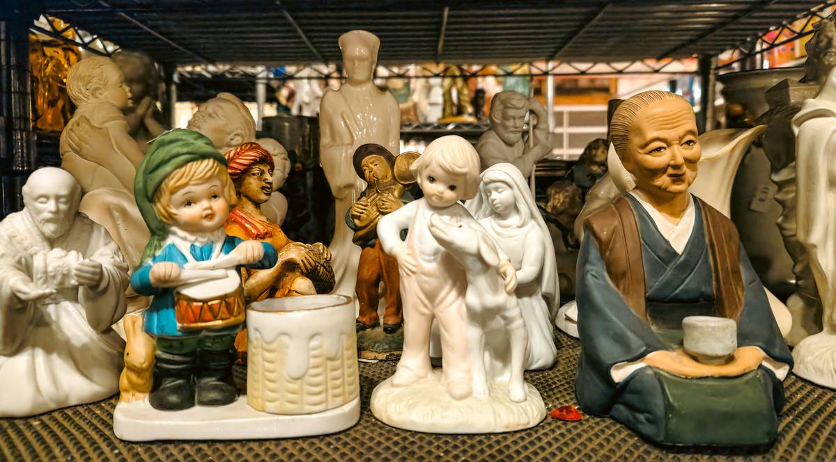 Elegant arrangement of decorative statues and figurines on a minimalist console table