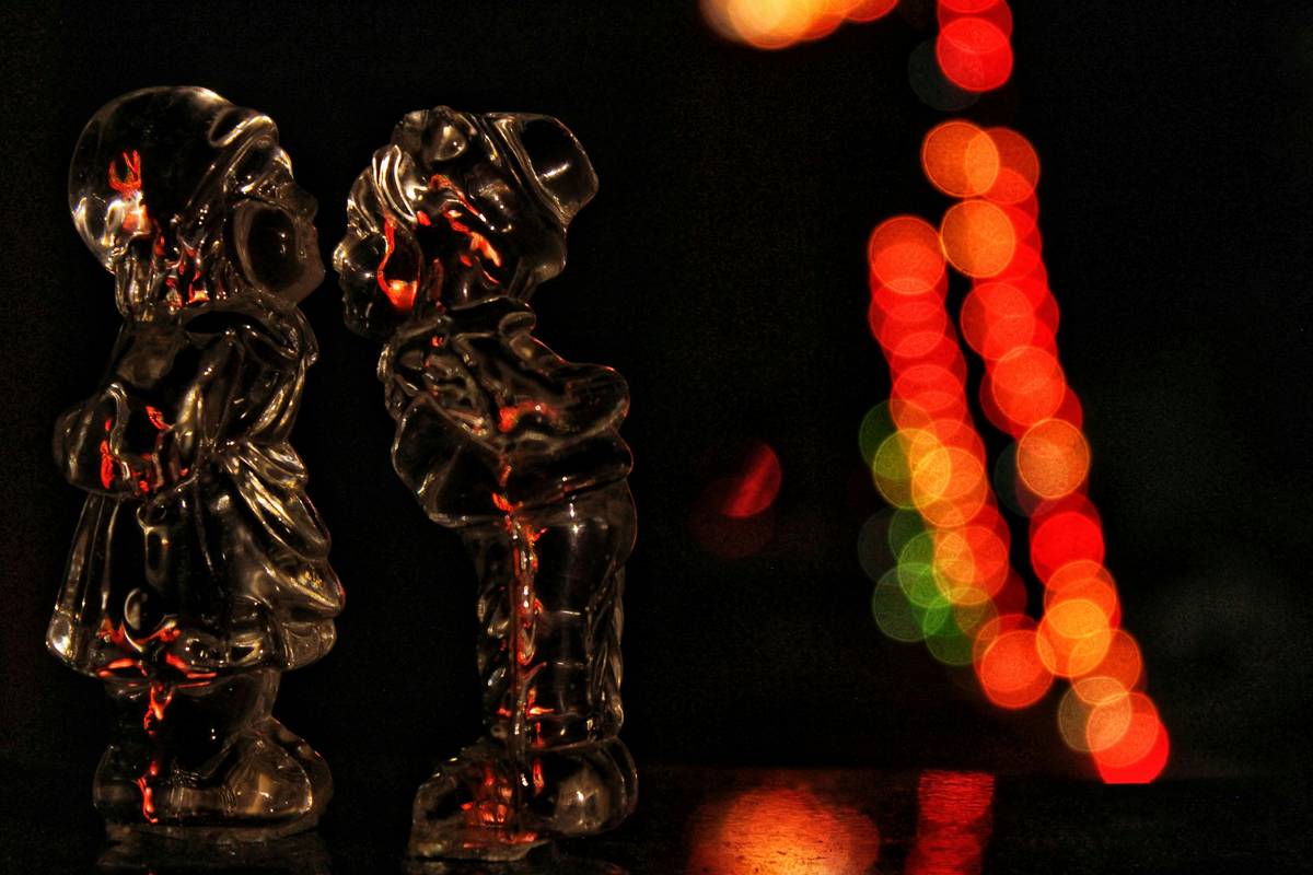 Elegant lighted figurines home decor displayed on a vintage wooden nightstand with soft ambient lighting