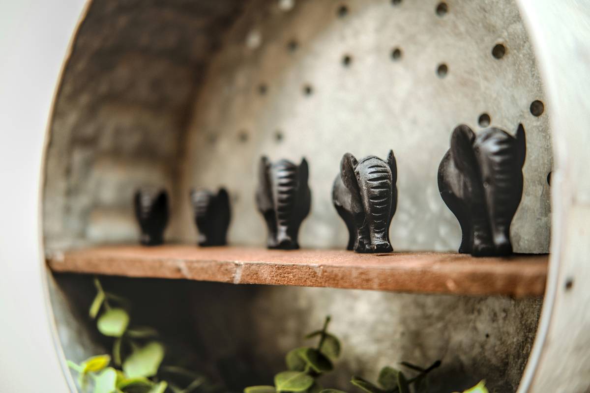 unique black figurines home decor displayed on a light wood console table with subtle ambient lighting