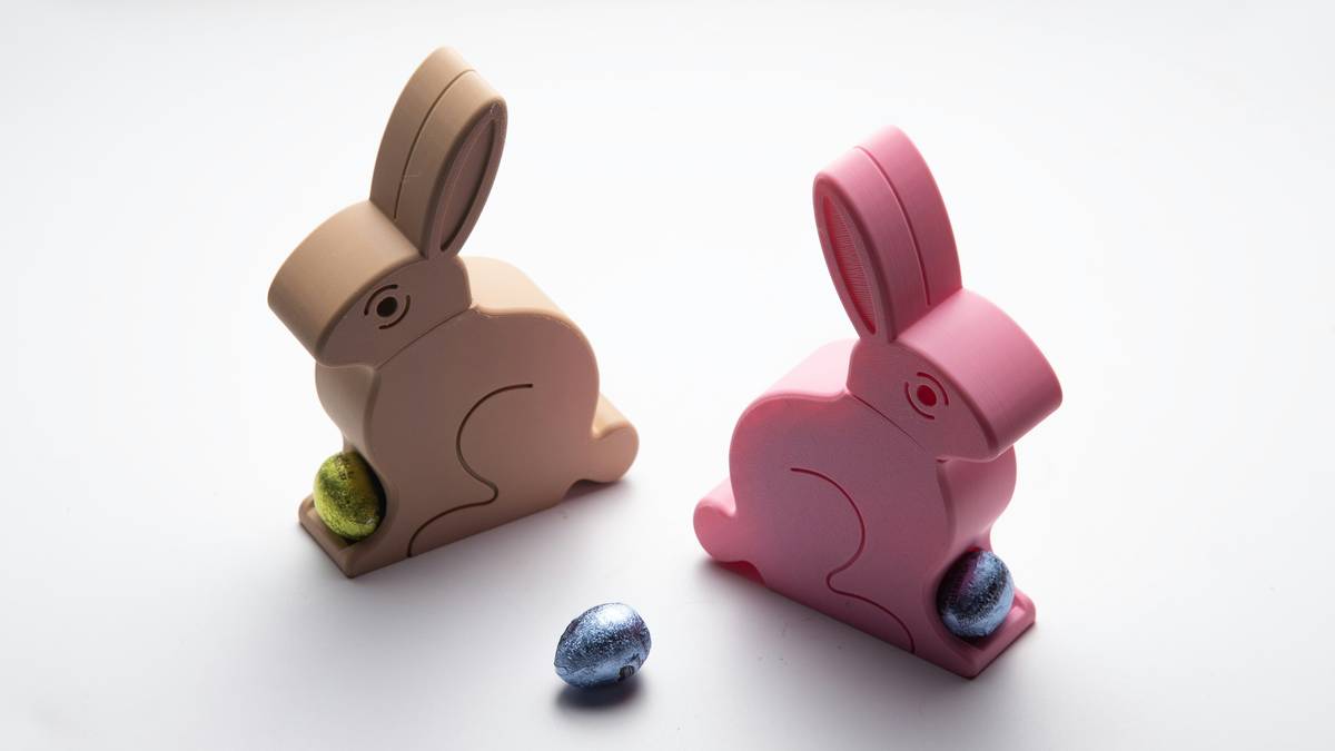 easter bunny figurines home decor displayed on a rustic wooden console table with pastel linens and fresh tulips